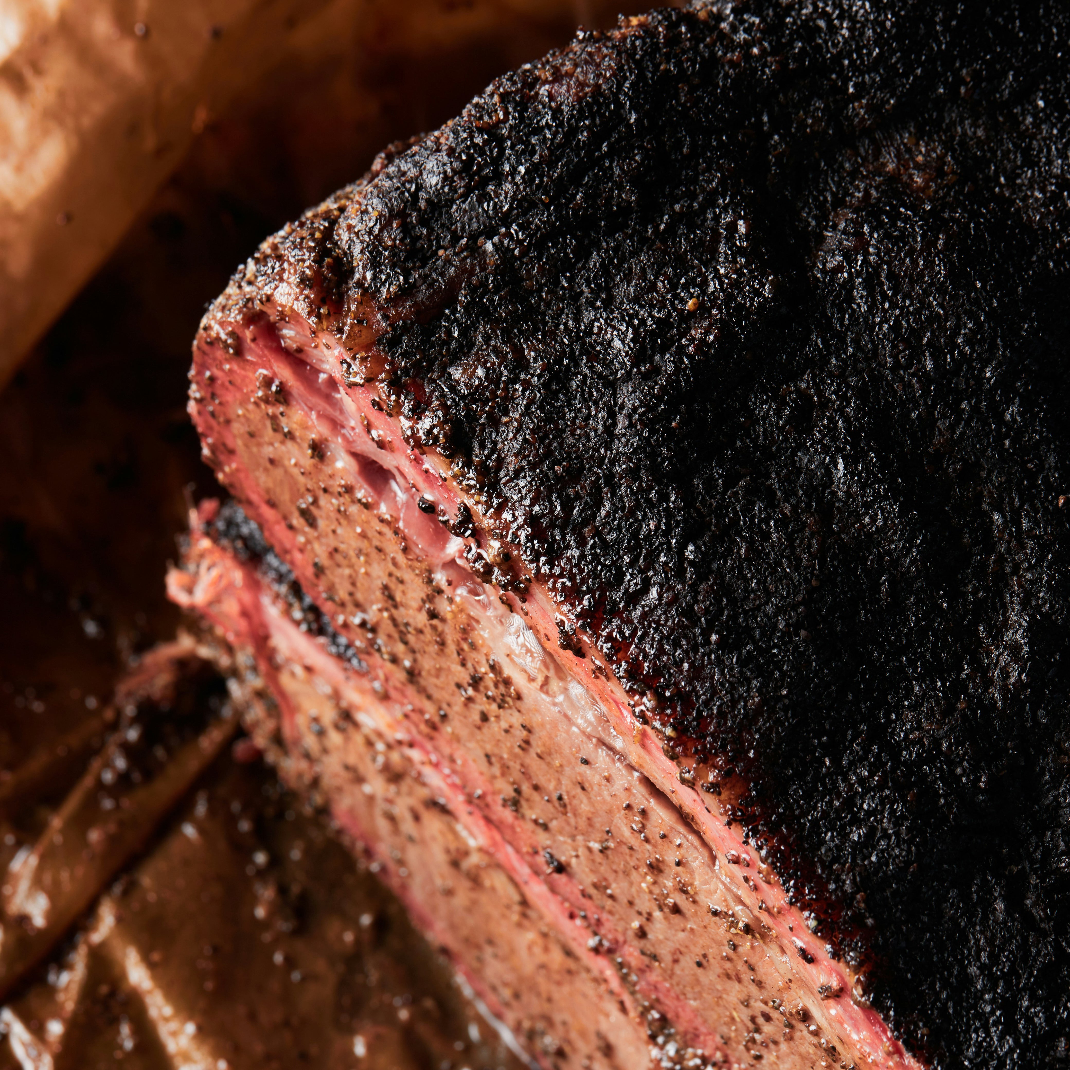 cut of smoked beef brisket on a craft paper